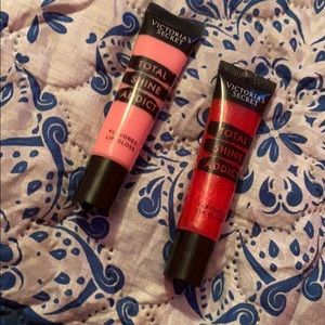 two tubes of Victoria secret lip gloss